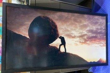 MAN ALONE PUSHING BOULDER