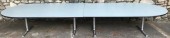 LARGE CONFERENCE TABLE, 4 CHROME BASES, 2 PIECE TABLETOP, HOLE NEAR MIDDLE ON ONE SIDE FOR ELECTRONIC CORDS
